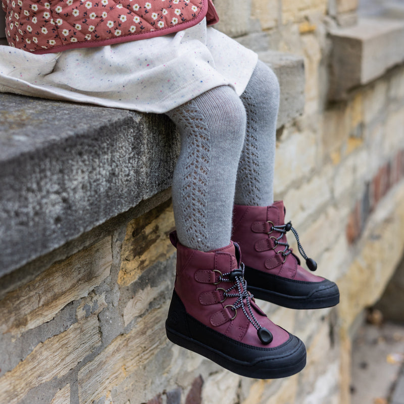 The berry First Step Finn worn outdoors