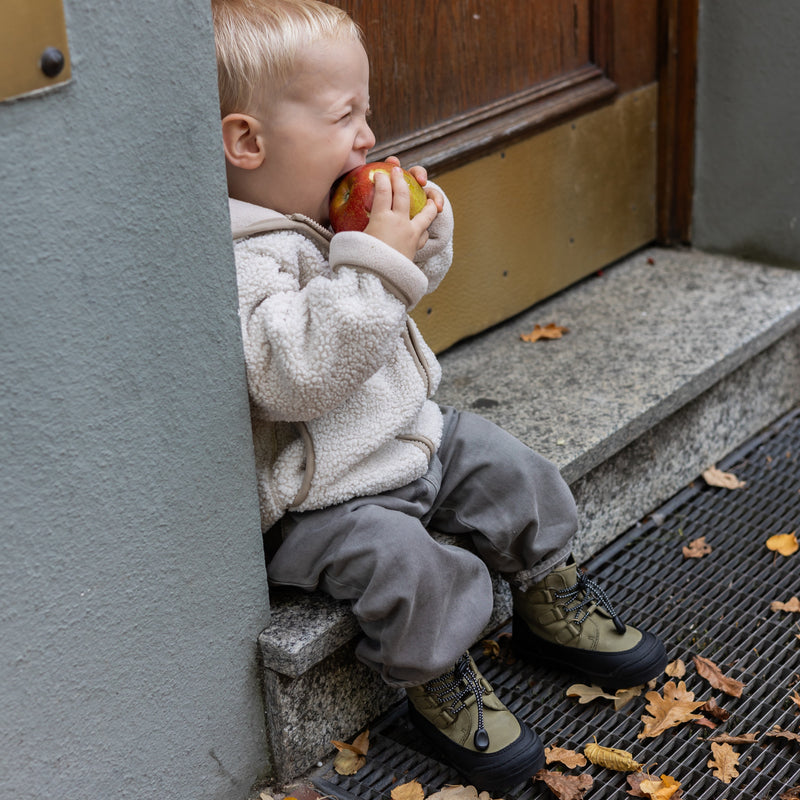 Child wearing the First Step Finn in khaki