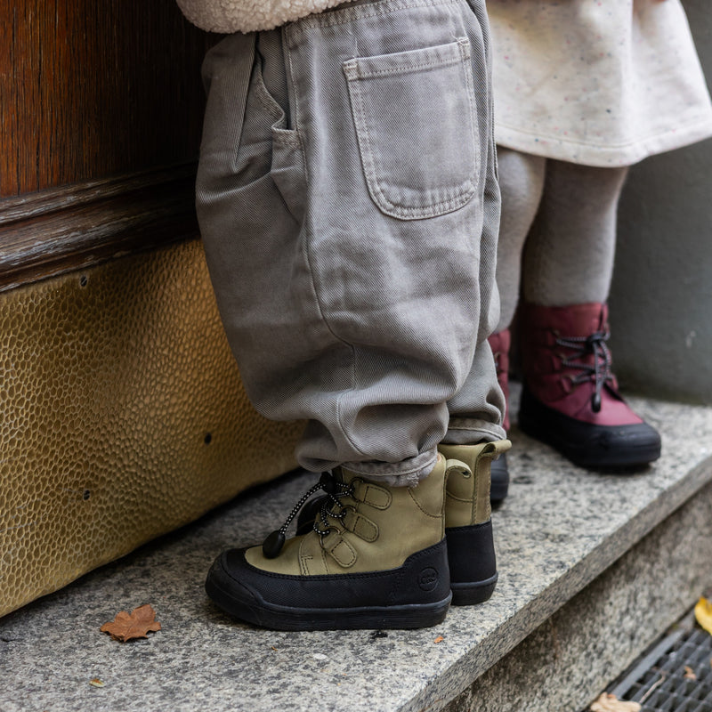 The khaki First Step Finn worn outdoors
