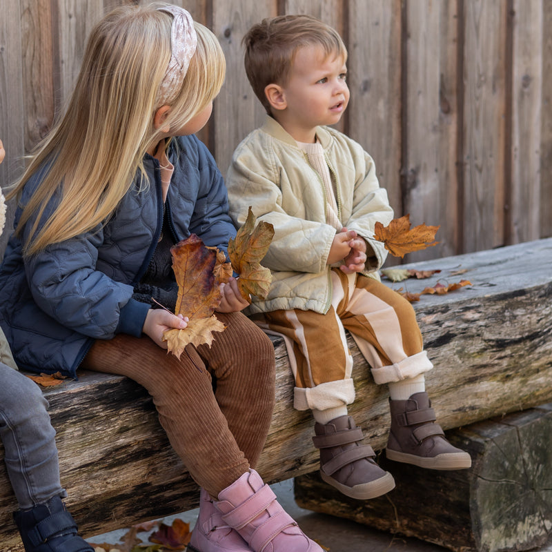 The brown First Step Boot worn on a fall walk