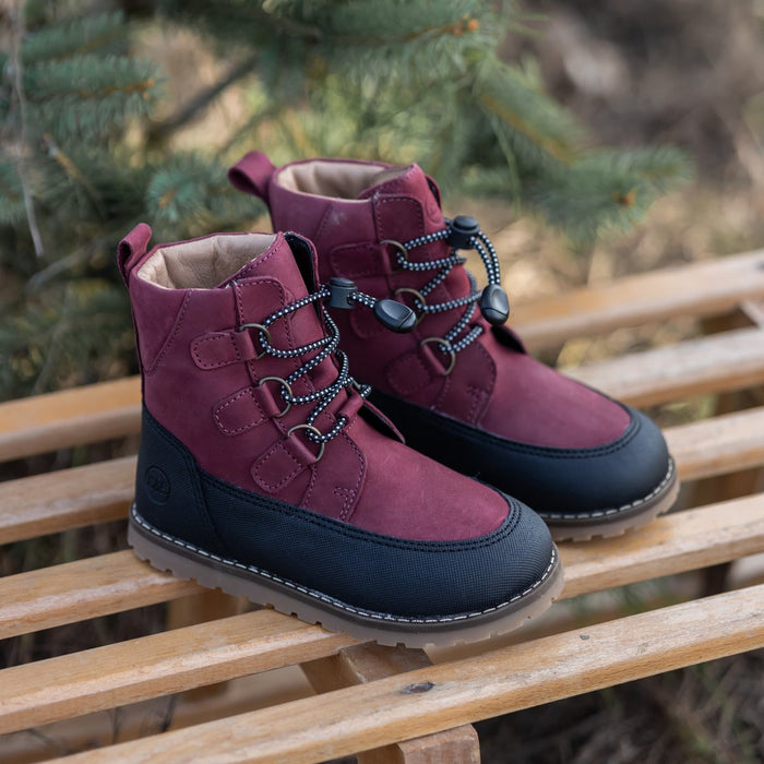 Berry Finn winter boots on a wooden sled