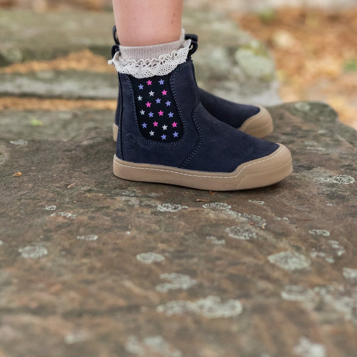 Navy winter Janne bootie with a star panel, worn with a lace sock